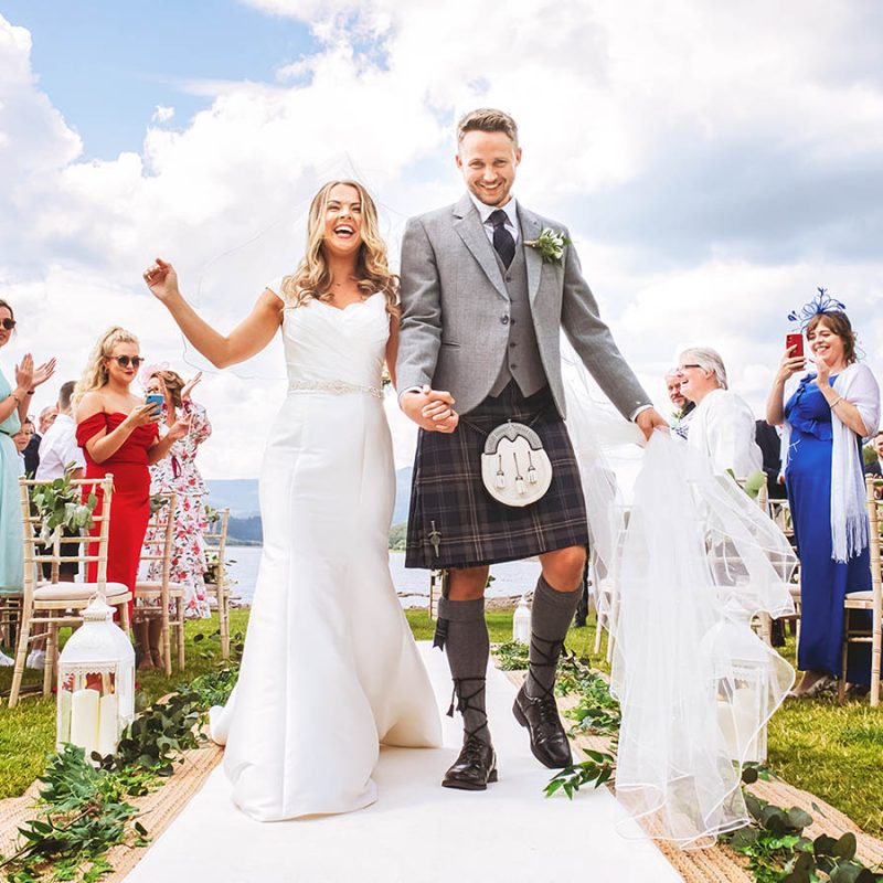 A bride and groom at their wedding at Loch Venachar
