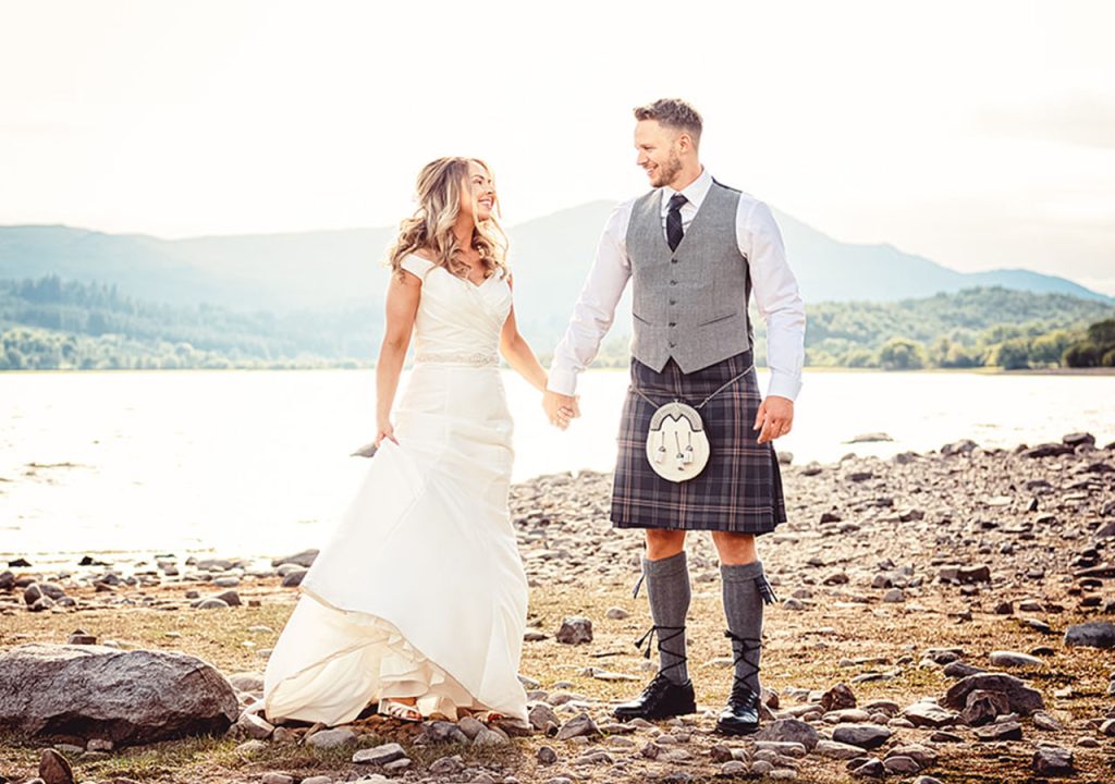 A bride and groom on the shores of Loch Venachar