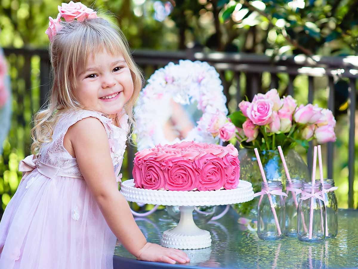 A young girl with her pink birthday cake