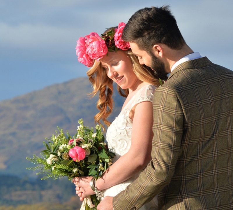 Couple with bright flowers getting married at Venachar Lochside