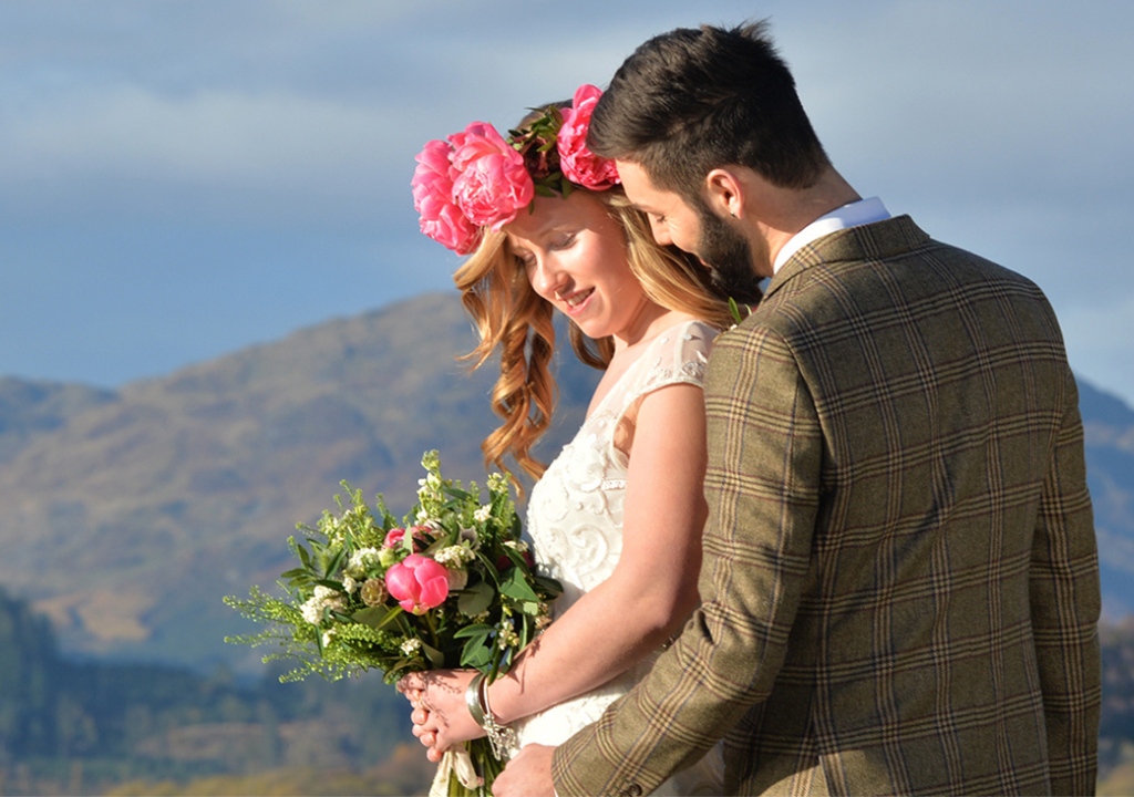 Couple with bright flowers getting married at Venachar Lochside