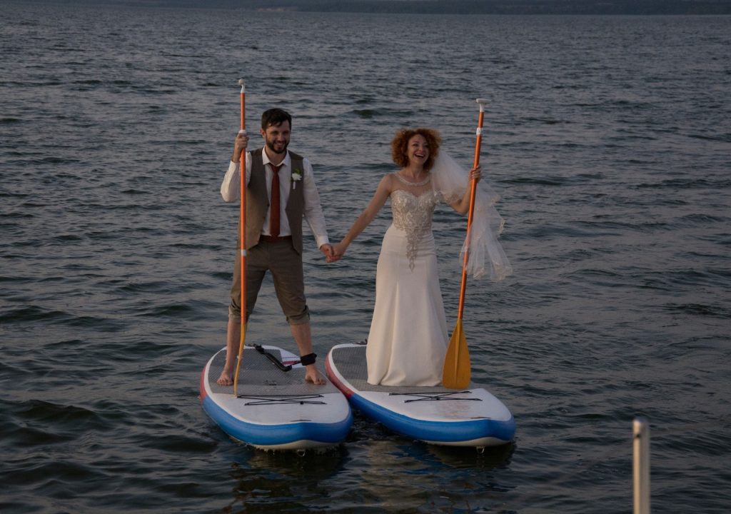 Bride and groom on a paddleboard