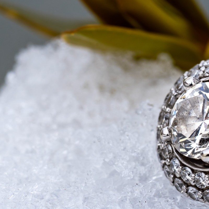Diamond ring in the snow with foliage