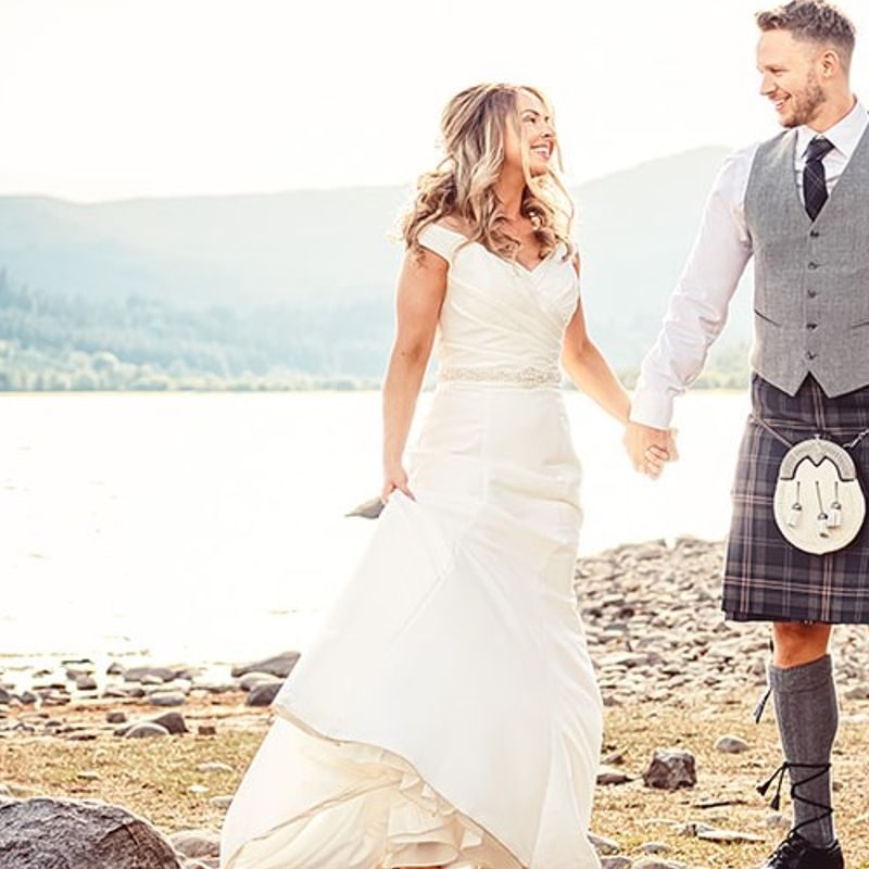 Wedding couple standing on the banks of Loch Venechar