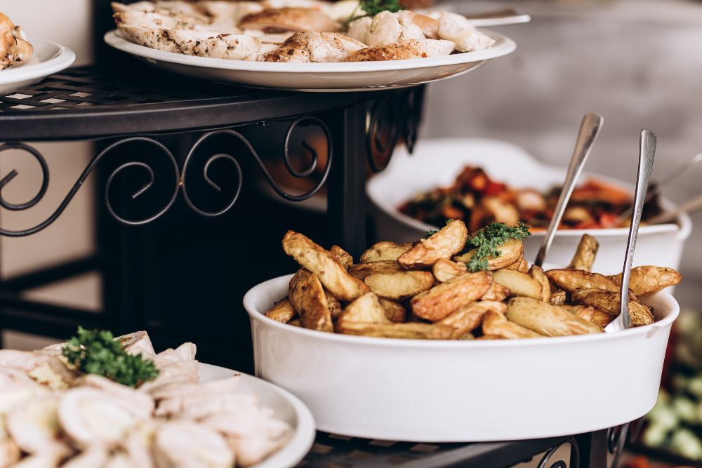 Buffet style service for an event. Chips in a bowl with serving spoon.