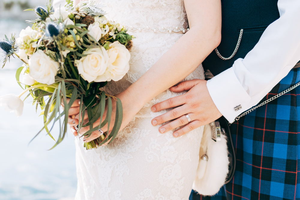 Bride and groom in traditional Scottish wedding attire
